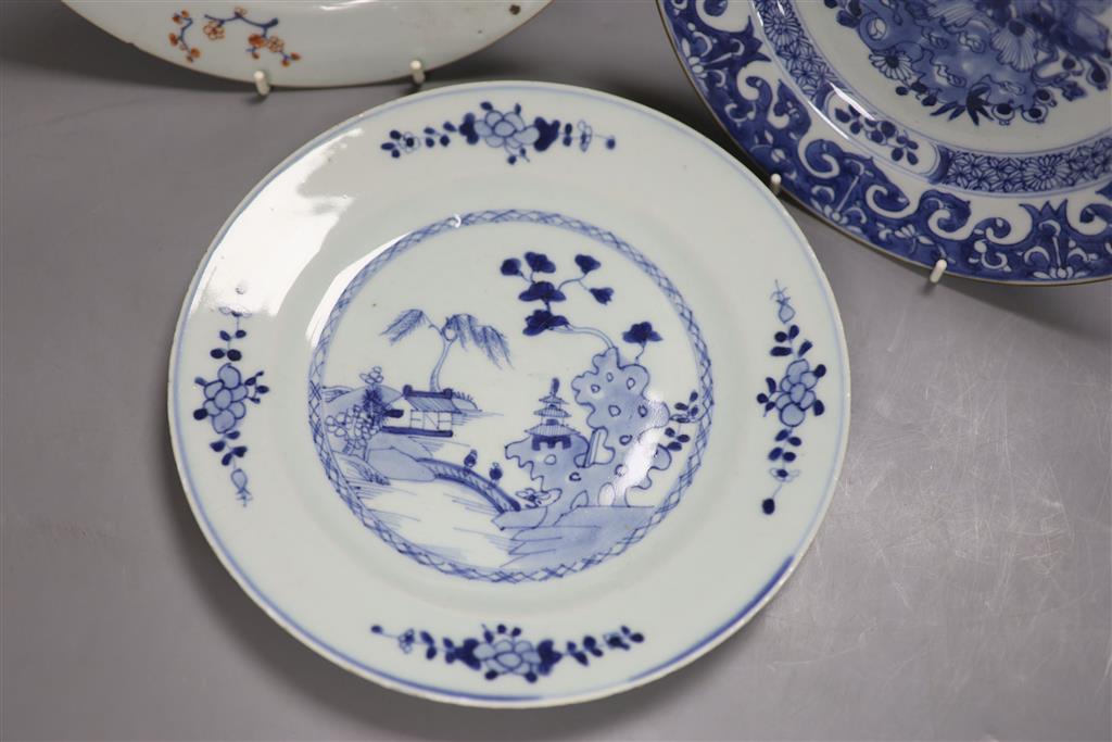 Three Chinese Qianlong plates, two blue and white, the third in Imari palette, diameter 23cm